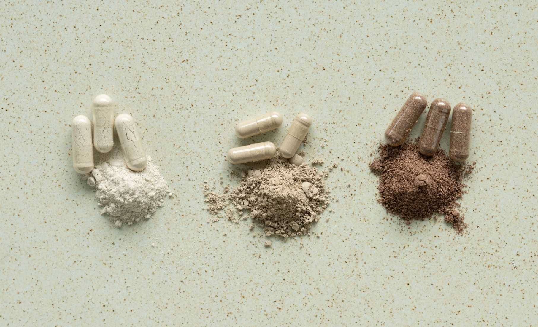 three types of deer velvet capsule and powder on a table.