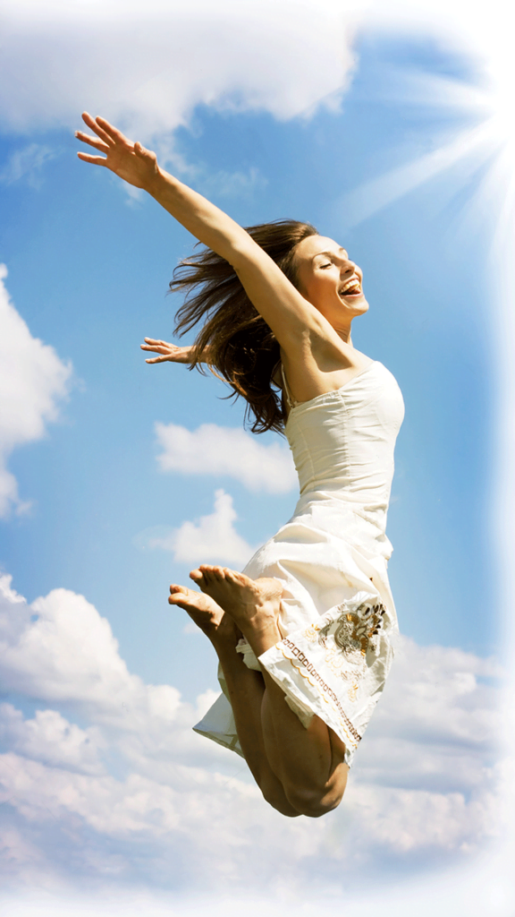 a woman in a white dress jumping in the air.