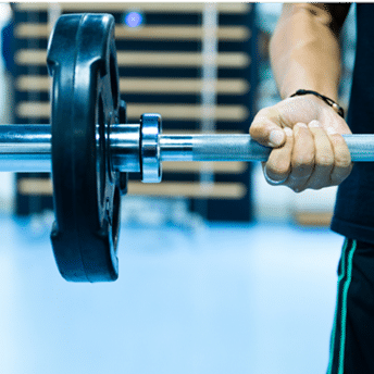 a person holding a barbell in a gym.