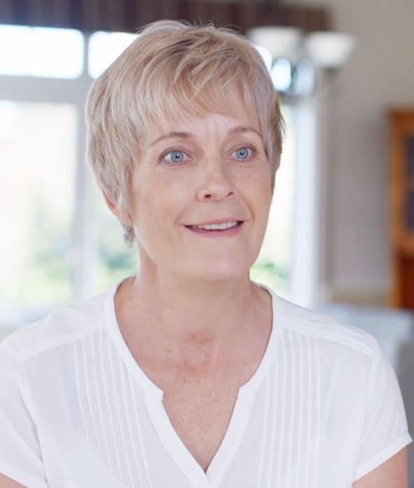 kathy cane in a white shirt smiling at the camera.